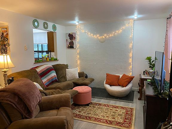 Living room with large bay window and pass-through window to kitchen.