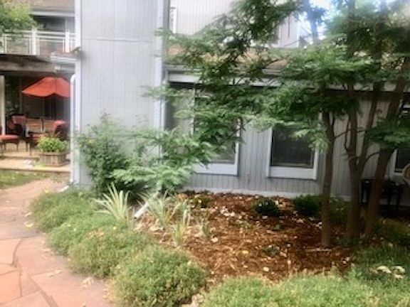 Flagstone walk to east to apartment front door