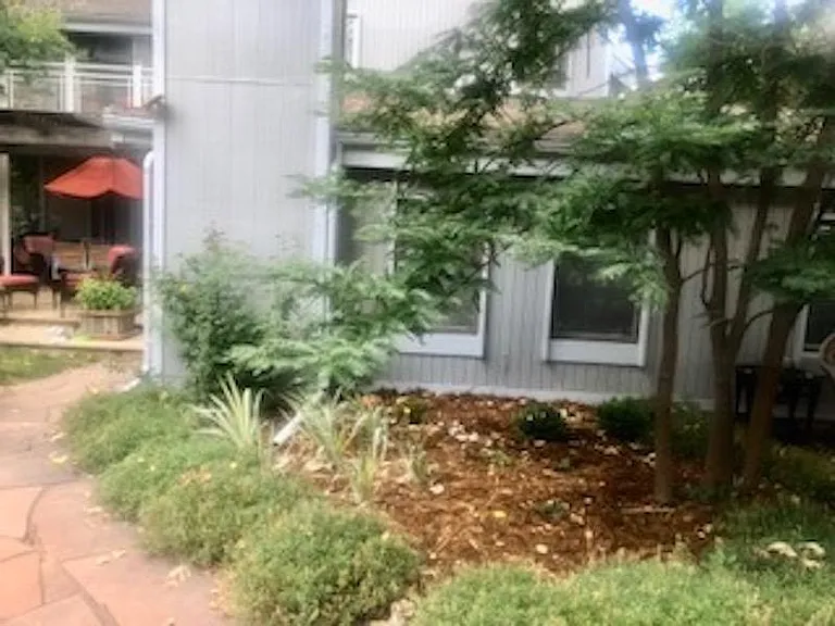 Flagstone walk to east to apartment front door