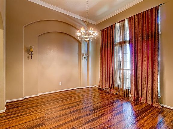 Formal Dining Room has Recent Paint and Wood Like Flooring