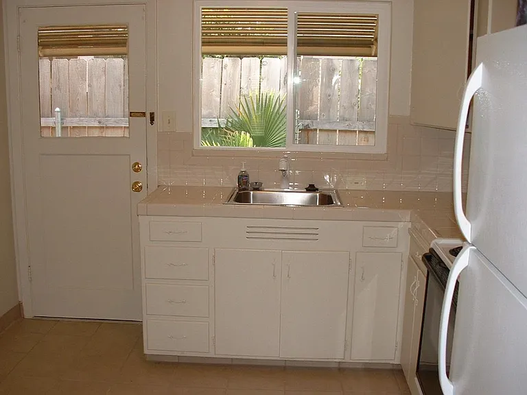 Kitchen with tile counters and floors