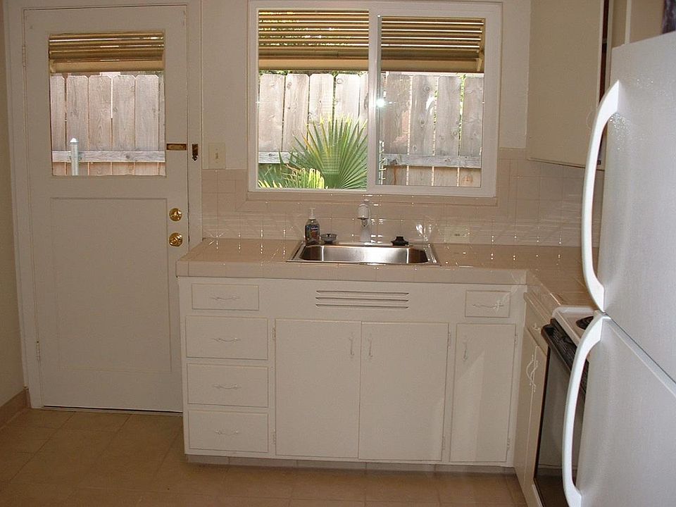 Kitchen with tile counters and floors