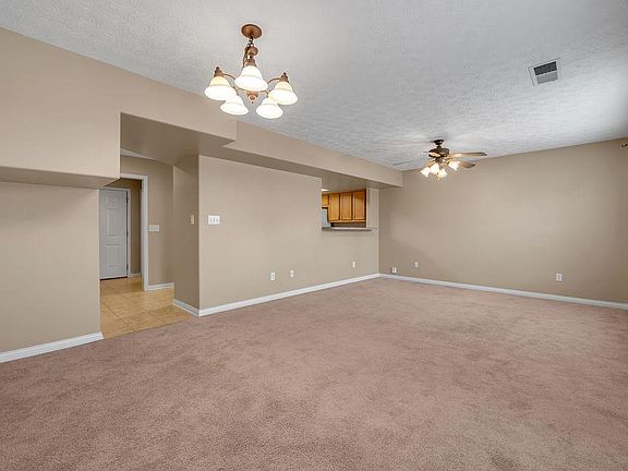 Living room with serving opening/bar overlooking the kitchen