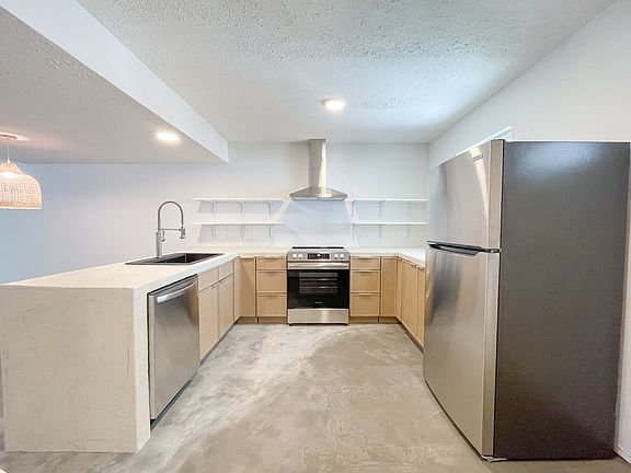 Kitchen with sealed concrete countertops and brand new appliances