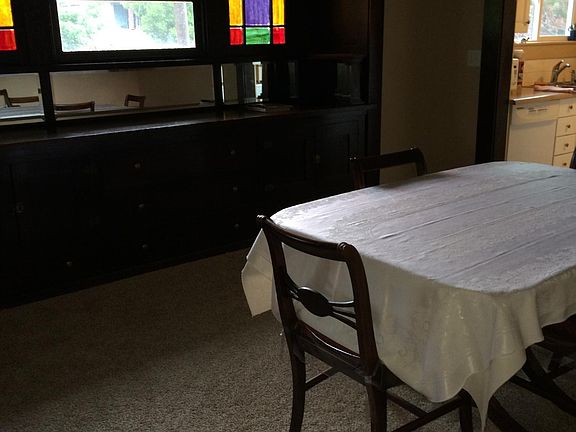 Dining room with nice stained glass accent and built in cabinets.