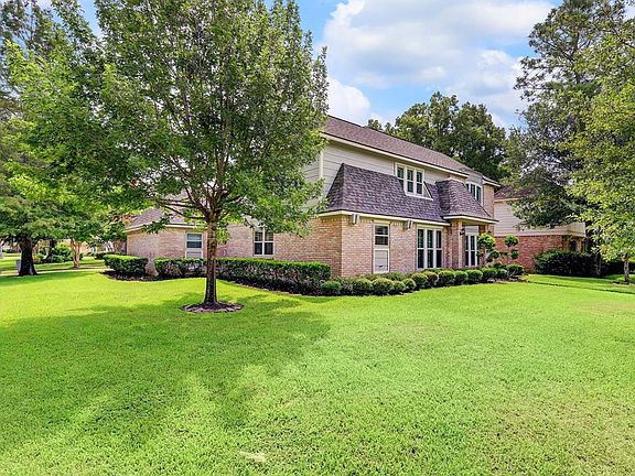 Side view of the property showcasing the large corner lot and recent roof update.