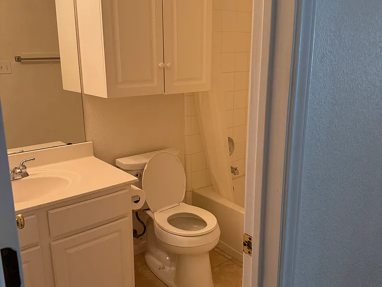 Second bathroom in hallway across from utility room and next to bedrooms 2 and 3