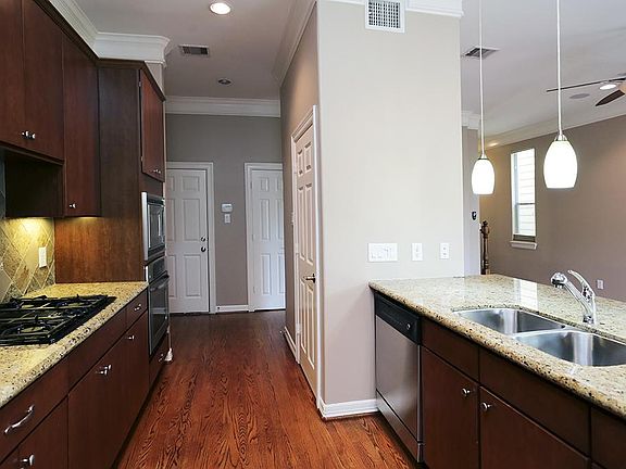 Beautiful kitchen with granite countertop, double sinks, gas cook top and stainless steel appliances