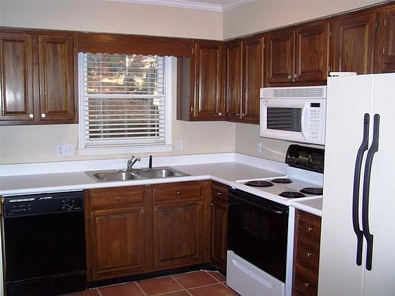 Well equipt kitchen has white appliances; refrigerator is included