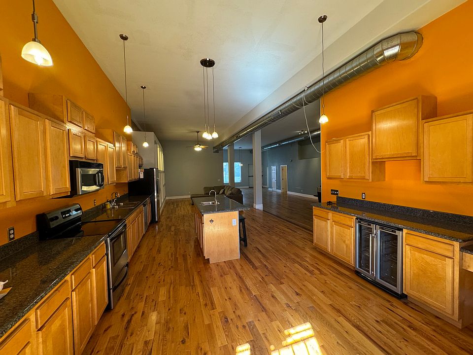 View from back door with kitchen in foreground and great room in the background.