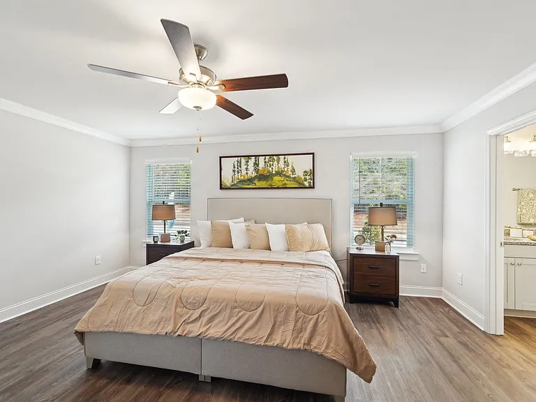 Primary Bedroom with king size bed and large window letting in nice natural light.