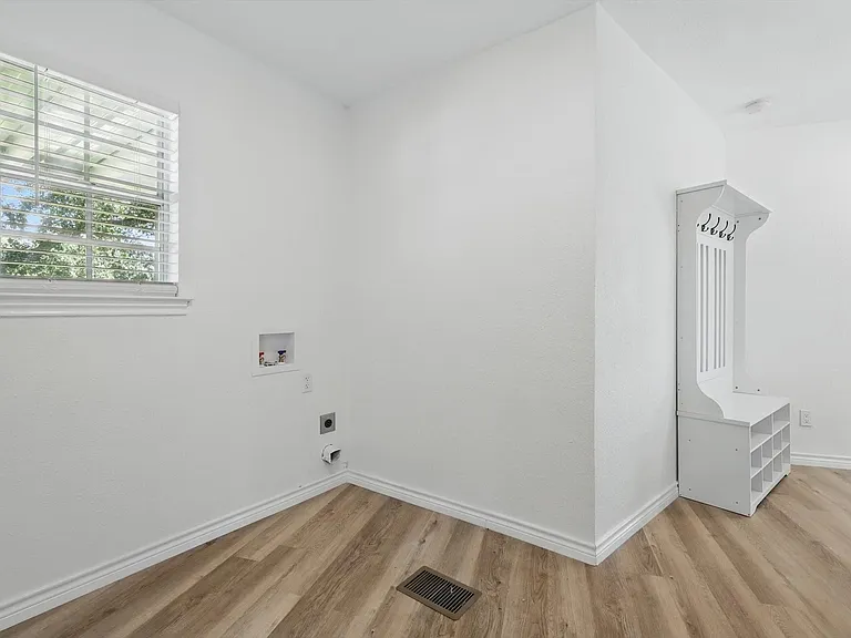 Laundry area with washer hookup, light wood-style flooring, baseboards, and electric dryer hookup