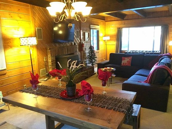Cozy living room with fireplace with insert (unfurnished and has vinyl plank flooring, not carpet).