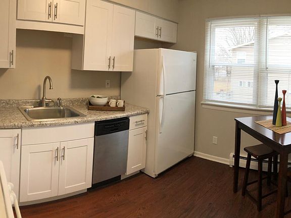 Eat-in kitchen with new cabinets, sink and countertops.