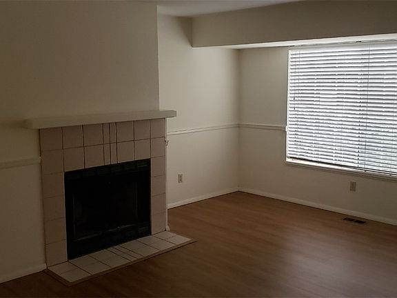 You will enter from the main door to the living room with wood floors.