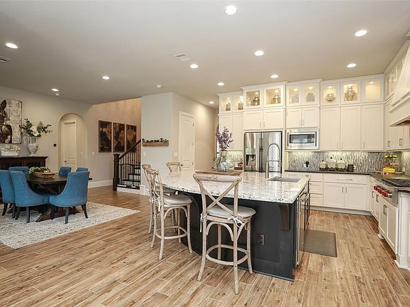 Welcome home! The chef in you will LOVE this kitchen! Notice the Wolf cook top! Lots of counter space and HUGE island for entertaining! Come see, come sigh, come buy!!!