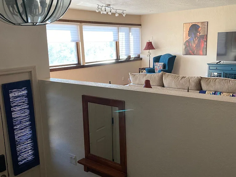 Peeking across the front entry to the living room from the kitchen area...