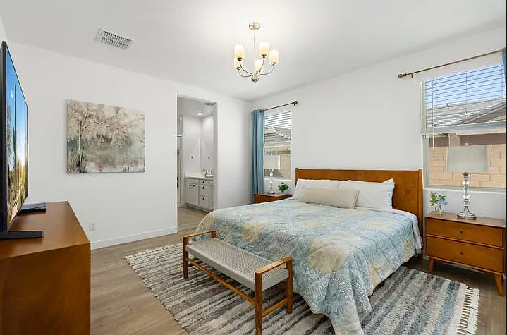 Spacious primary suite with king bed and private ensuite bathroom.
