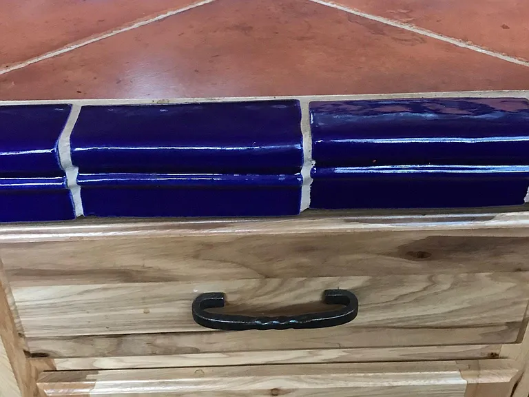 Detail of kitchen cabinet, counter and backsplash. Customized high quality tile work. Hickory wood cabinets with forged iron handles. Tiles are Mexican handmade and high quality Italian.