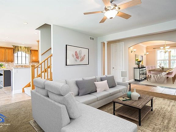 LIVING ROOM WITH STONE FIREPLACE AND TONS OF WINDOWS TO BACKYARD