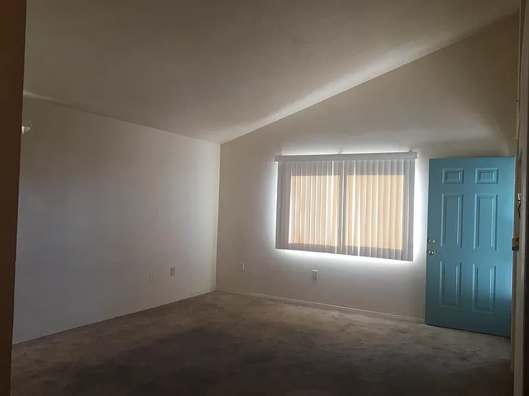 3rd view of living room. PS - carpet has been replaced by vinyl plank flooring.