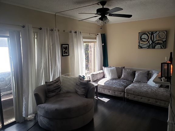 Living room has extra large windows and small balcony.