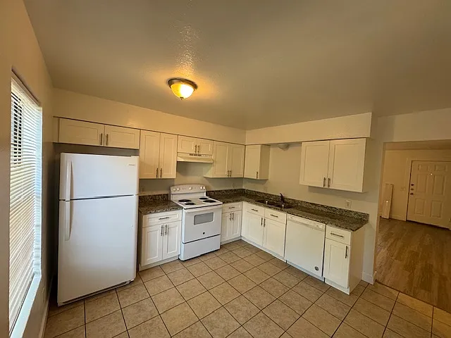 Kitchen with loads of storage with window giving loads of natural light.
