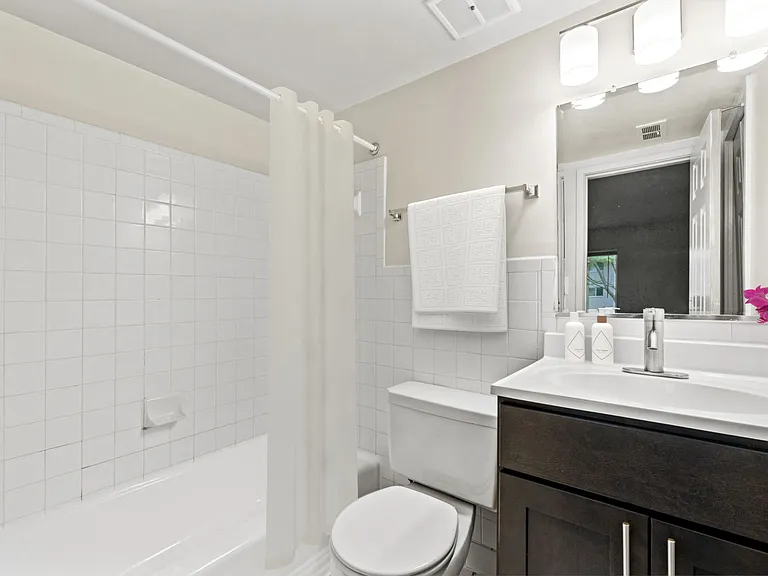 Updated bathroom with tub and shower and modern cabinetry
