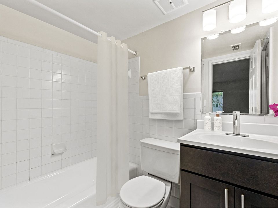 Updated bathroom with tub and shower and modern cabinetry