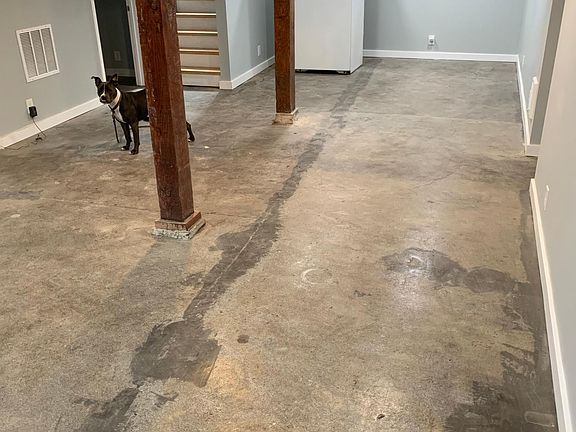 1000 square feet with clean and sealed concrete floor with large wood beams and only 7 steps down.