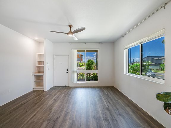 Living room features a command center for storing devices, printer, etc.
