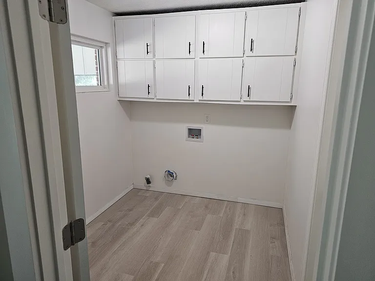 Large laundry room with lots of storage.