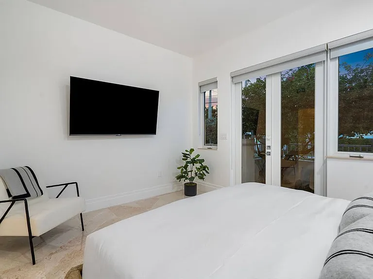 Relax in this tranquil bedroom featuring soft natural tones and private garden access.