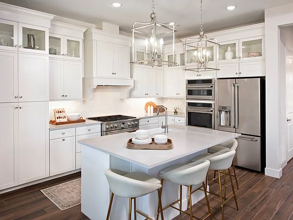 Kitchen with glass upper cabinets and pendant lighting