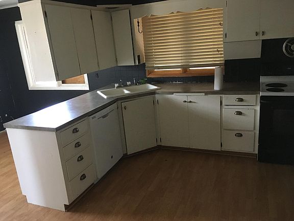 Kitchen midview with bar dishwasher and stove in pic