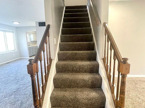 Stairwell located in center of home leading to landing of bedroom entrances.