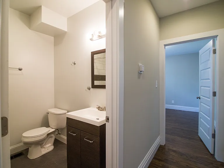 hallway leads to bathroom and bedrooms
