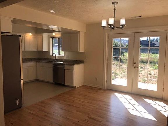 Dining room with french doors overlooking backyard and neighboring pasture.