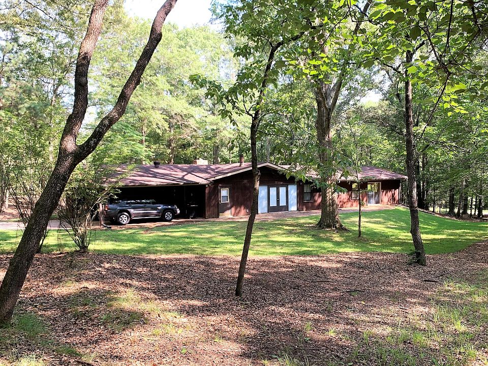 Rear view showing backyard and 2-car covered parking.