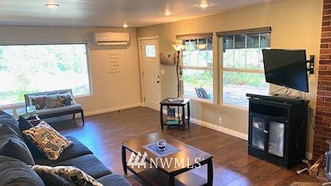 Front family room with beautiful floors and large windows bringing in tons of natural light.