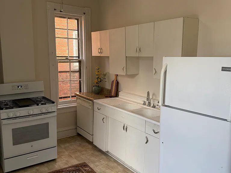 Freshly painted kitchen with ceiling fan.