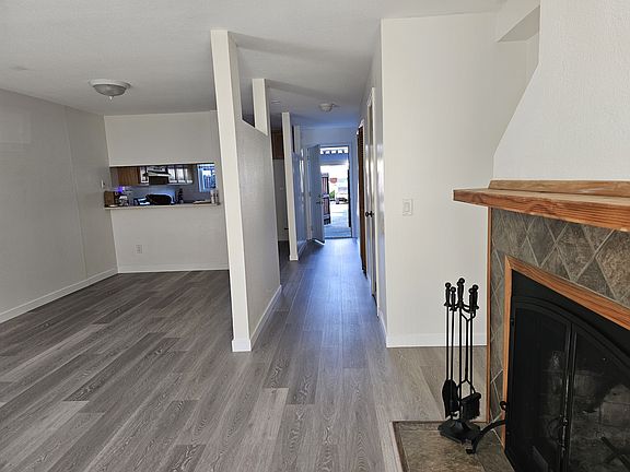 Dining room to the left, fireplace to the right. View to the front door from the living room.