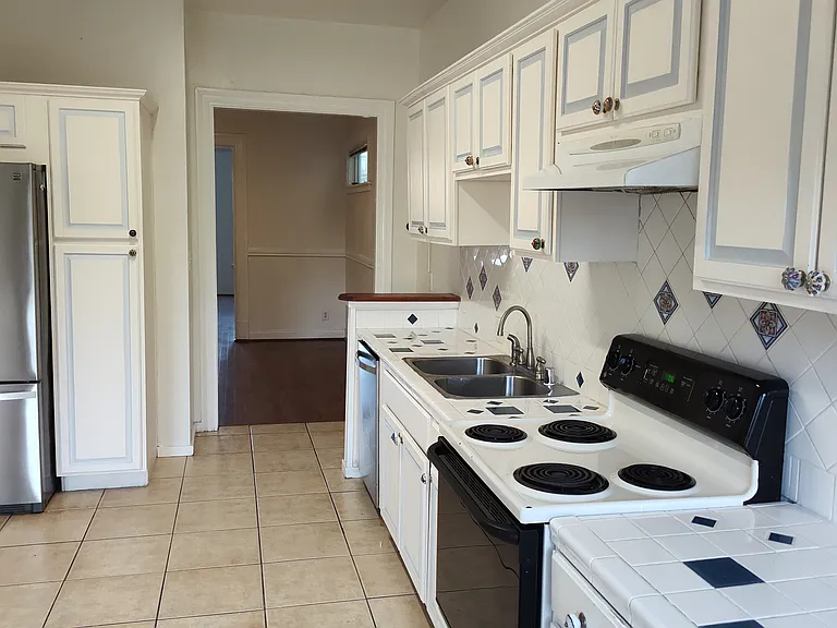 standing at kitchen window looking at kitchen and dining room