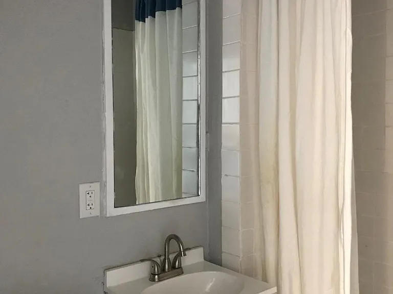 Bathroom with new tile, toilet, vanity and fixtures.