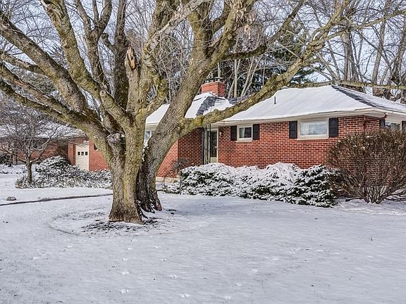 Front of home with mature trees