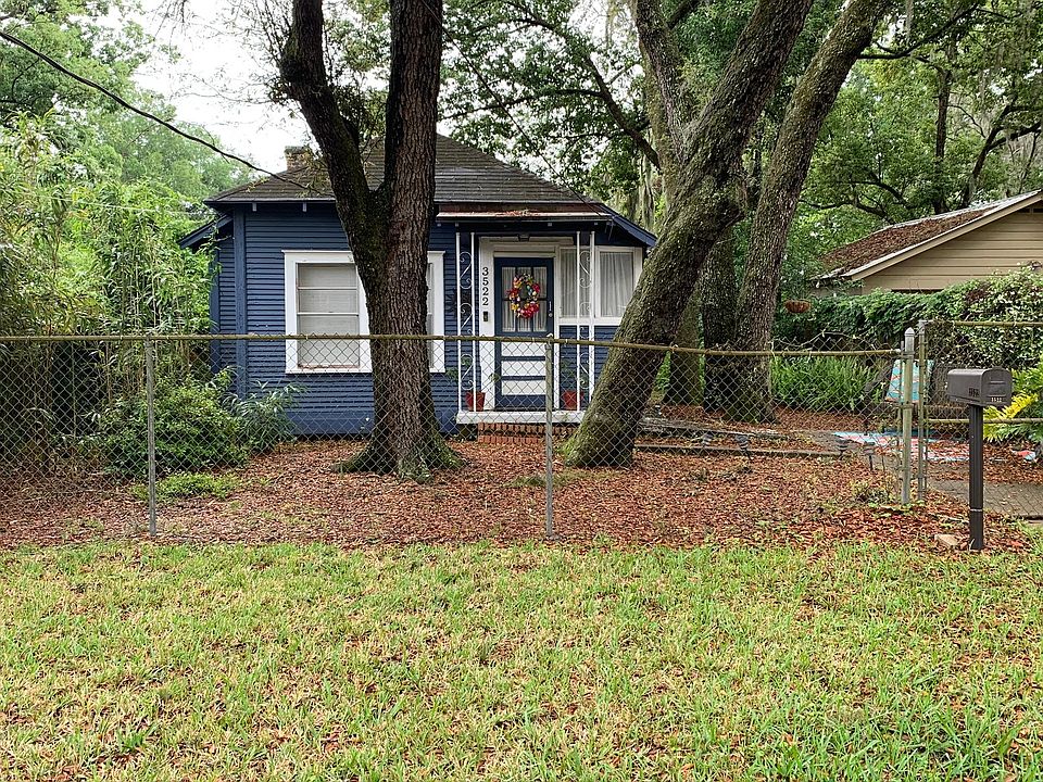 Front elevation with large fenced yard.