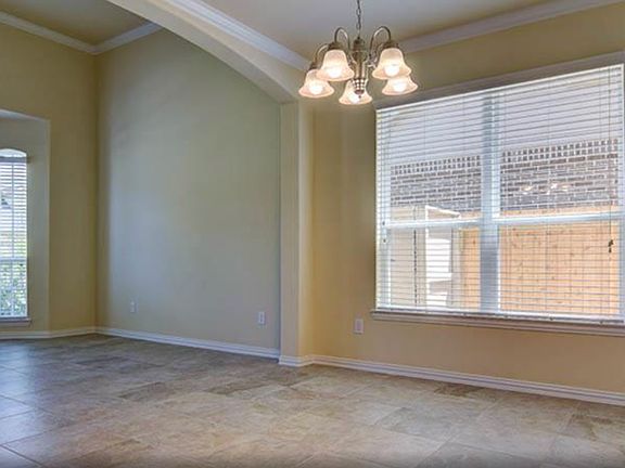 Tall ceilings and beautiful arches! Dining area and front sitting/ living room