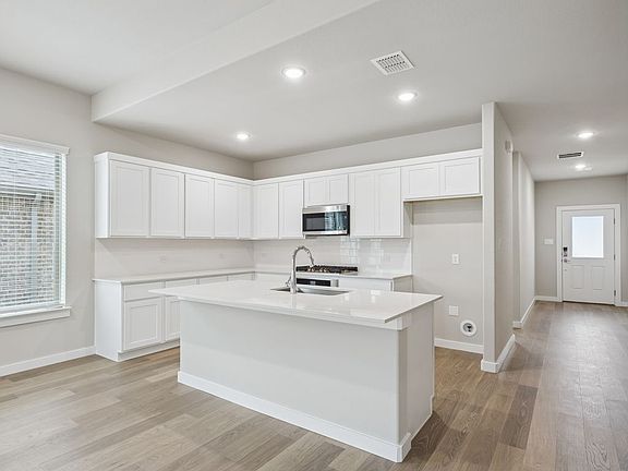 Kitchen in the Stanley II home plan by Trophy Signature Homes - REPRESENTATIVE PHOTO