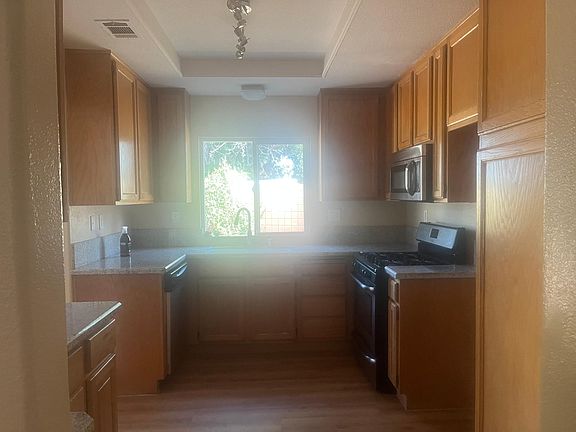 Kitchen with dishwasher, stove, and microwave