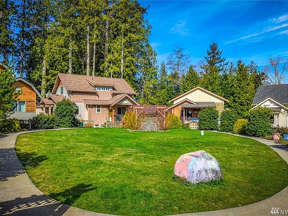 No cars in this area! Homes encircle a shared grassy lawn, with sidewalk from parking lot to your front door
